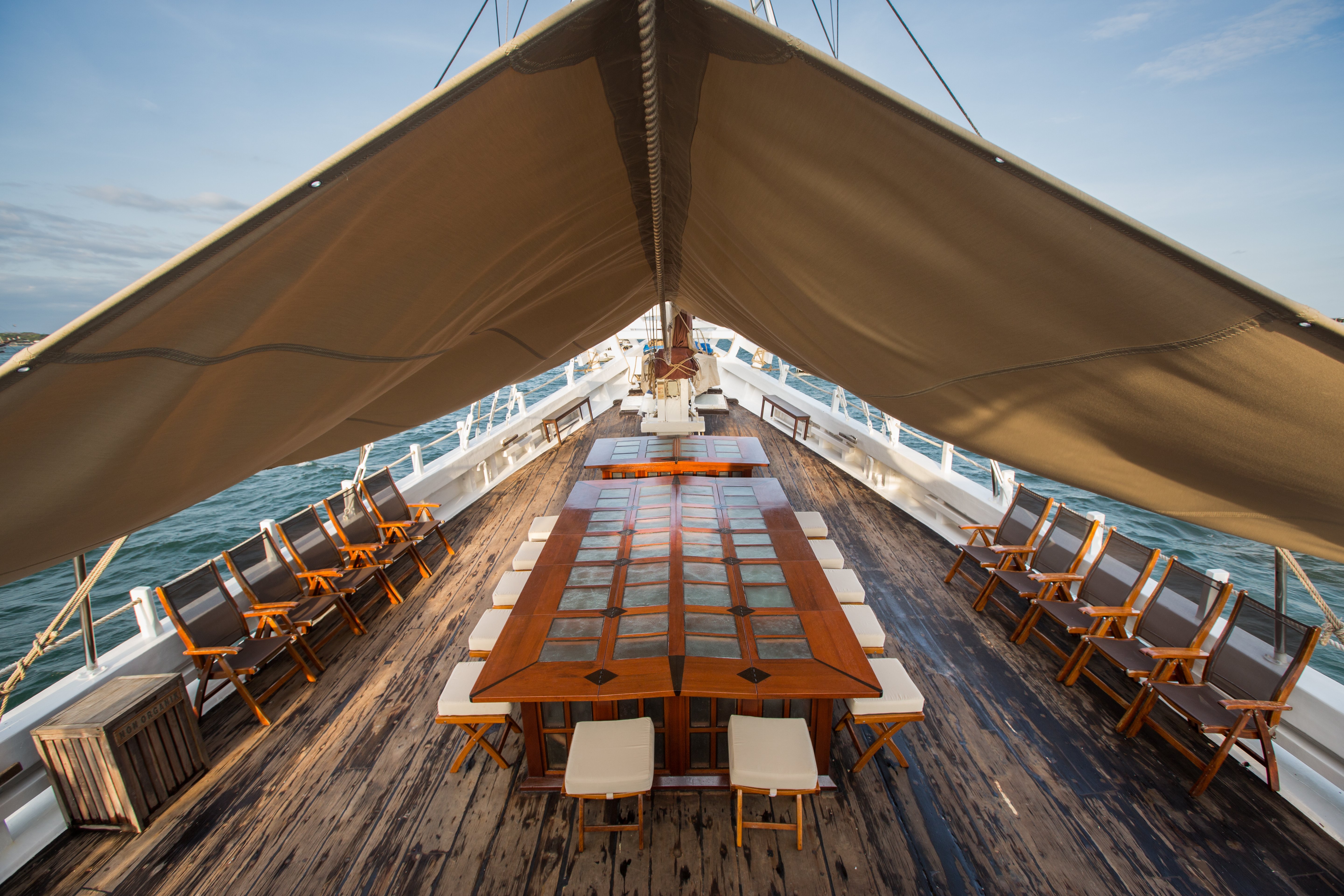 The SeaTrek deck has a long dining table covered by a gazebo.