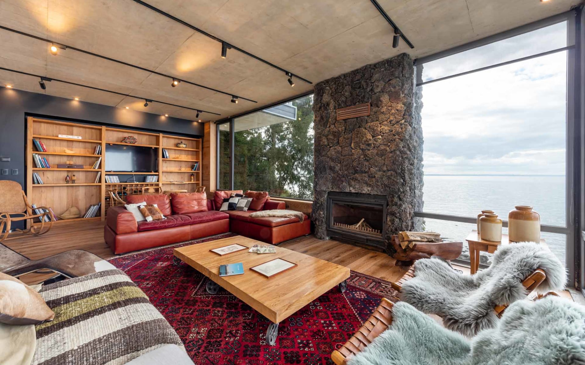 The private villas have floor-to-ceiling windows, a stone fireplace and low sofas with soft pillows and blankets. 