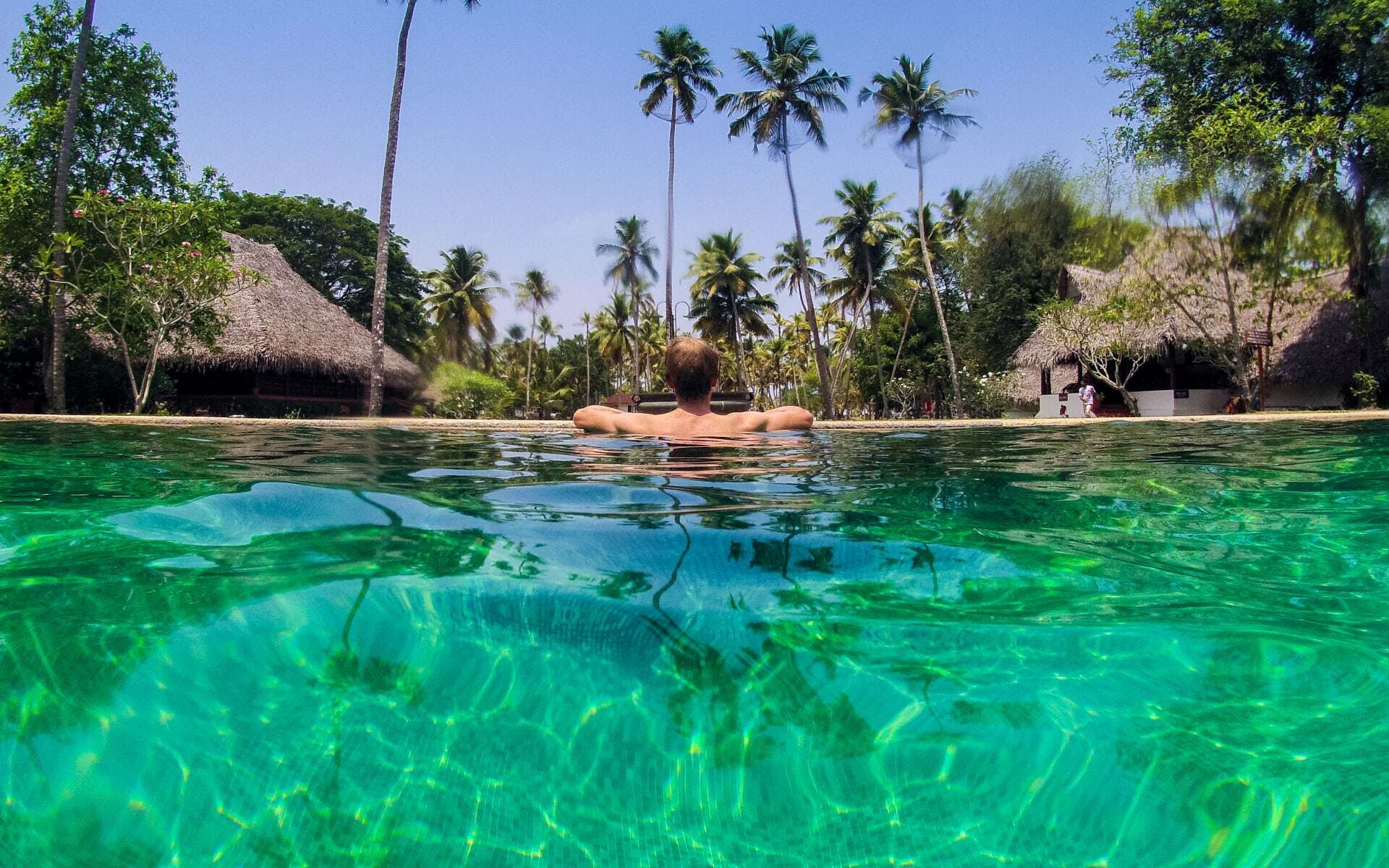 A man swims in the pool at Marari Beach Resort.