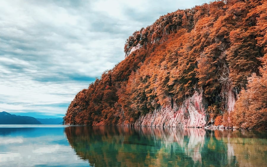 Autumn coloured trees over a crystal clear lake