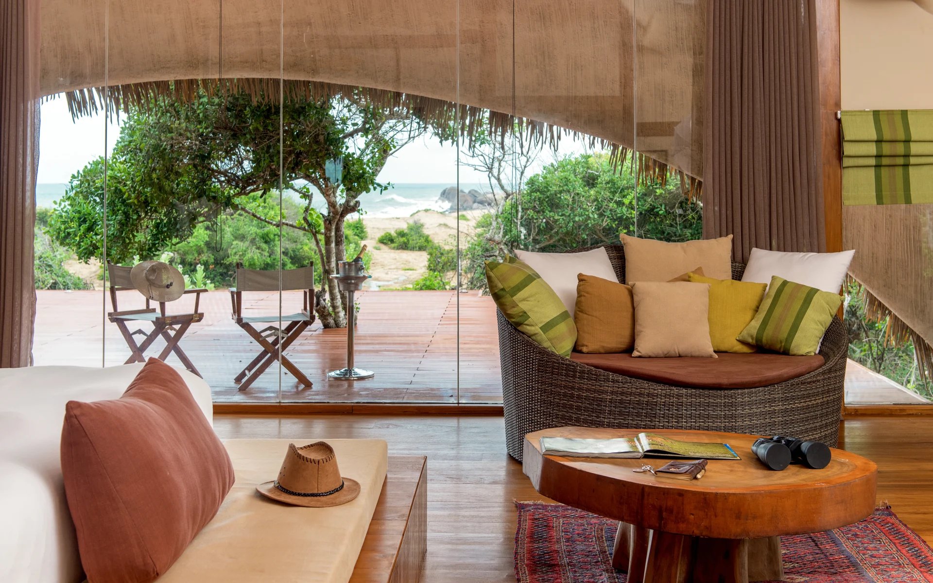 The room has a chair and floor-to-ceiling windows. 
