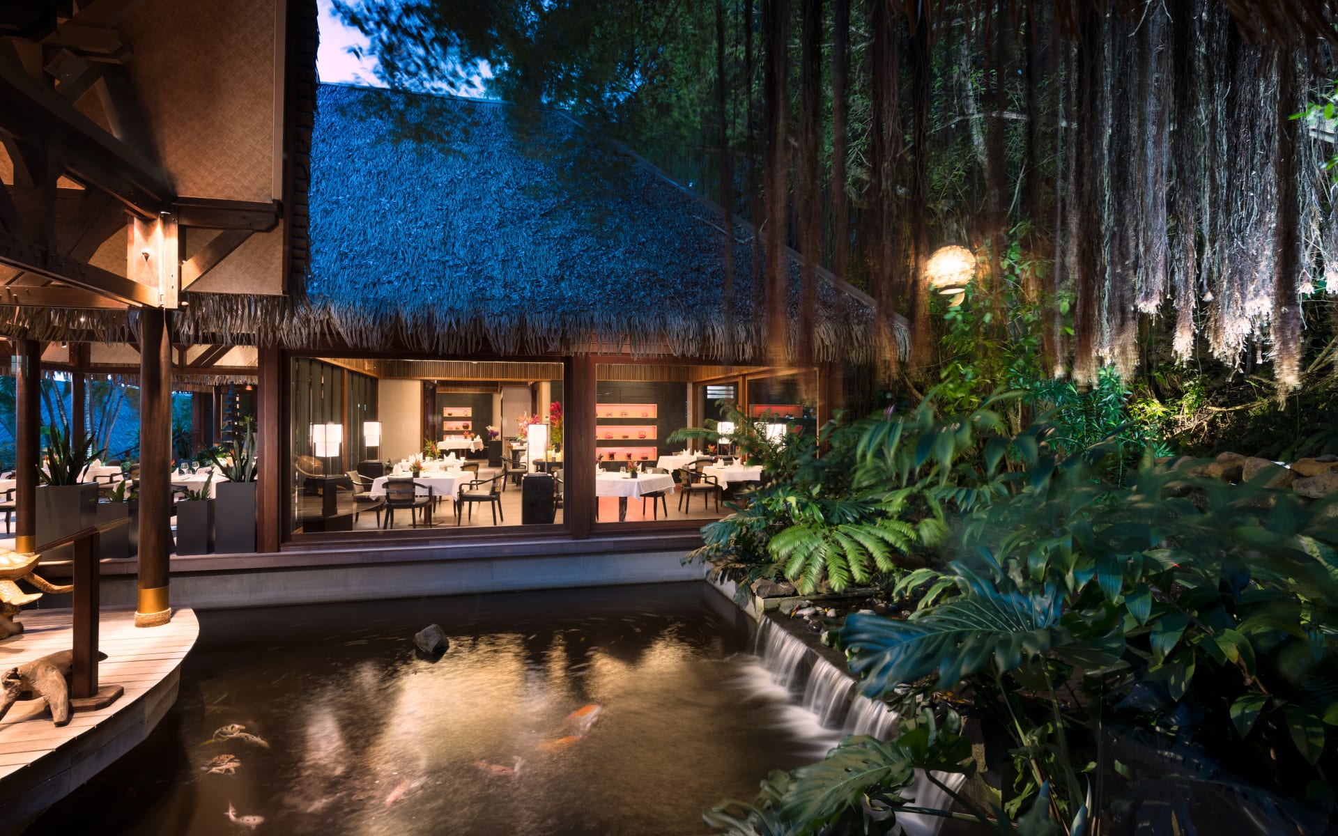 The restaurant has a koi-pond and jungle aesthetic. 