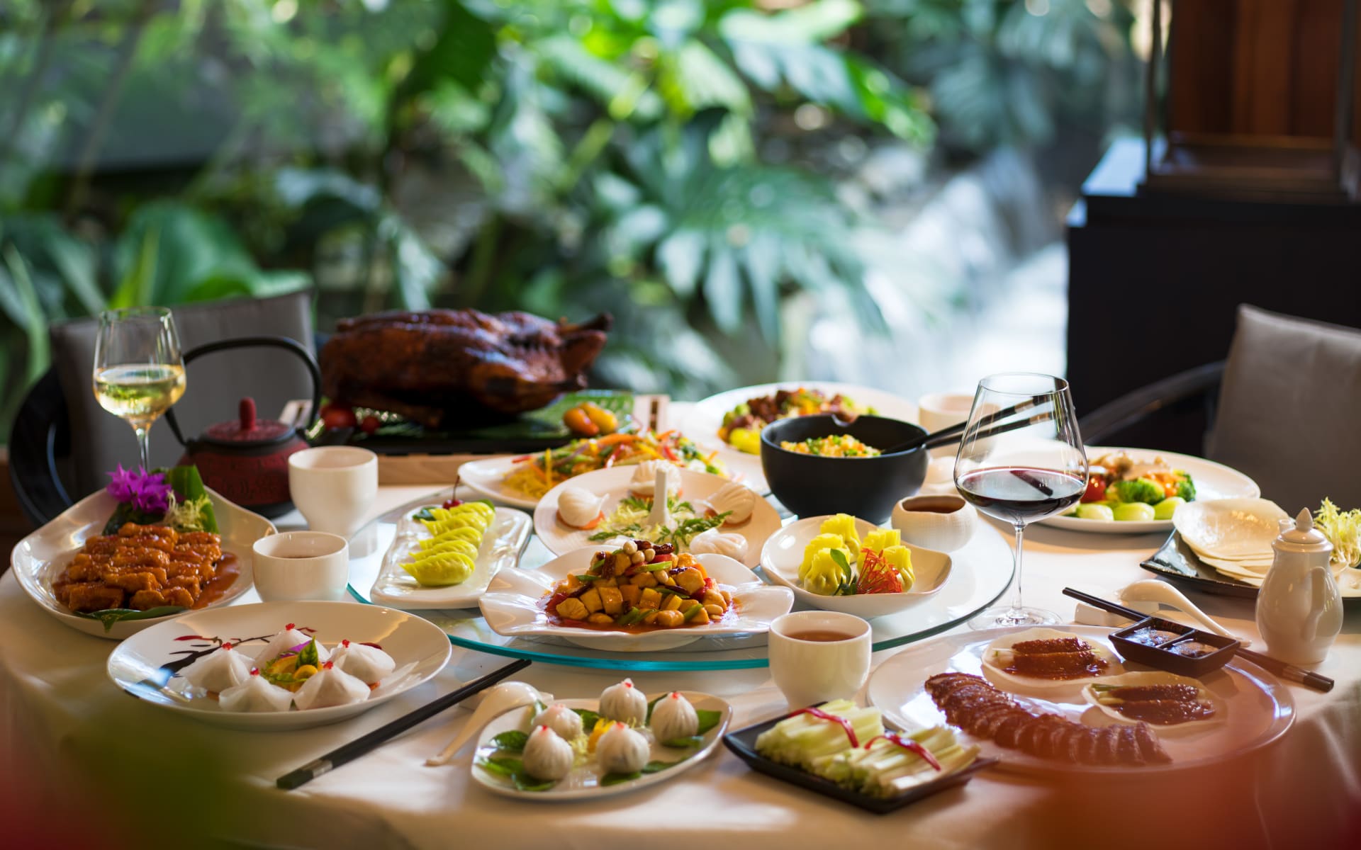 A table is full of Chinese food. 