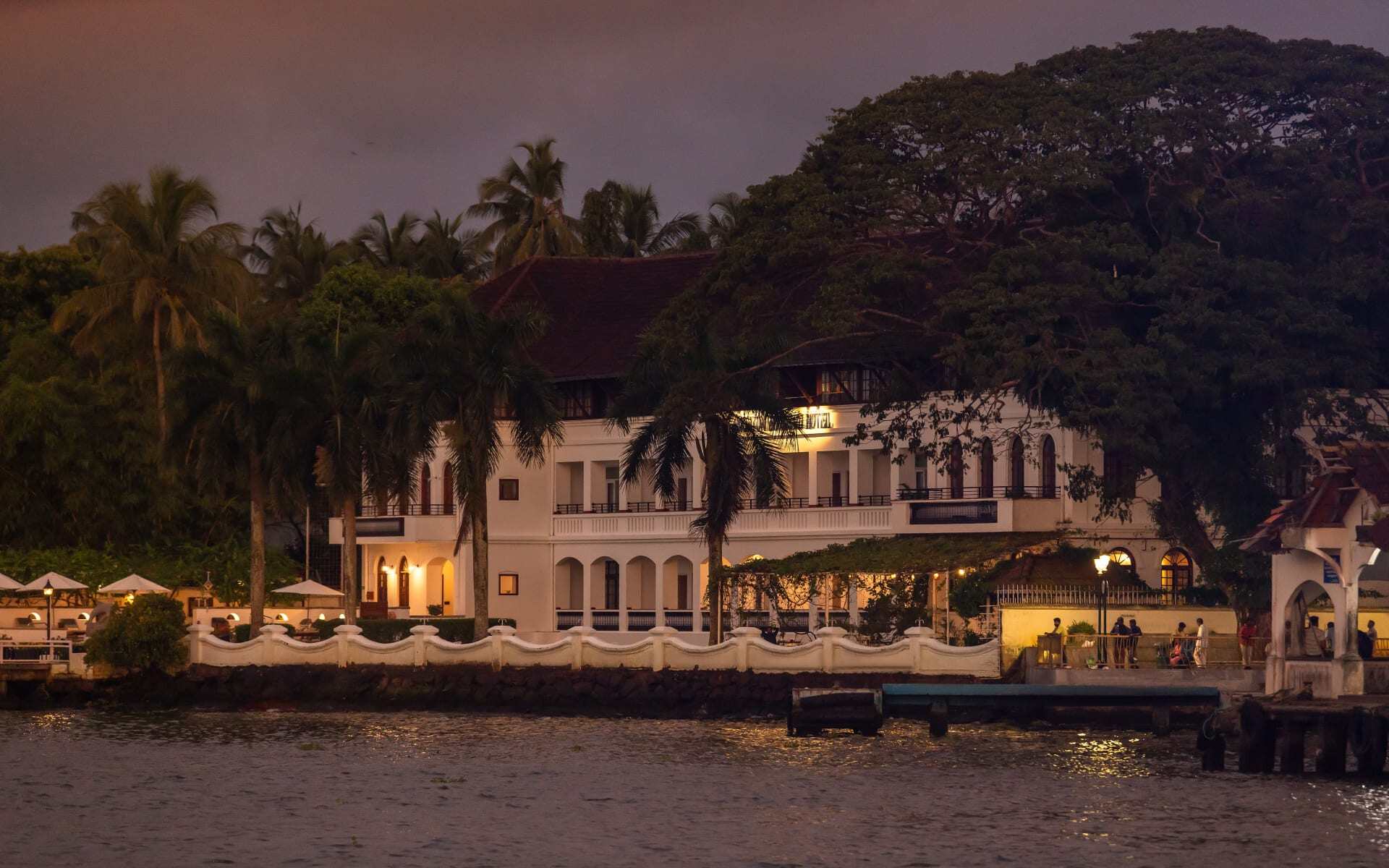 Brunton Boatyard has a white painted exterior and is surrounded by palms.