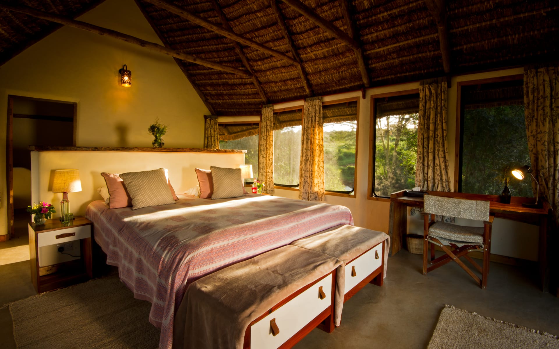The exterior of the estancia is dressed in white wood-panelling with a red roof.