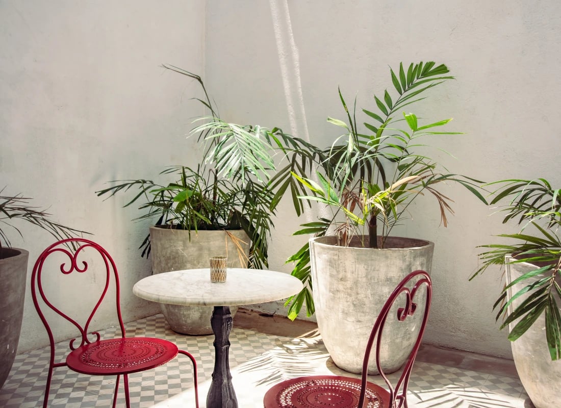 Two red seats are placed either-side of a table, perfect for a private dining experience.