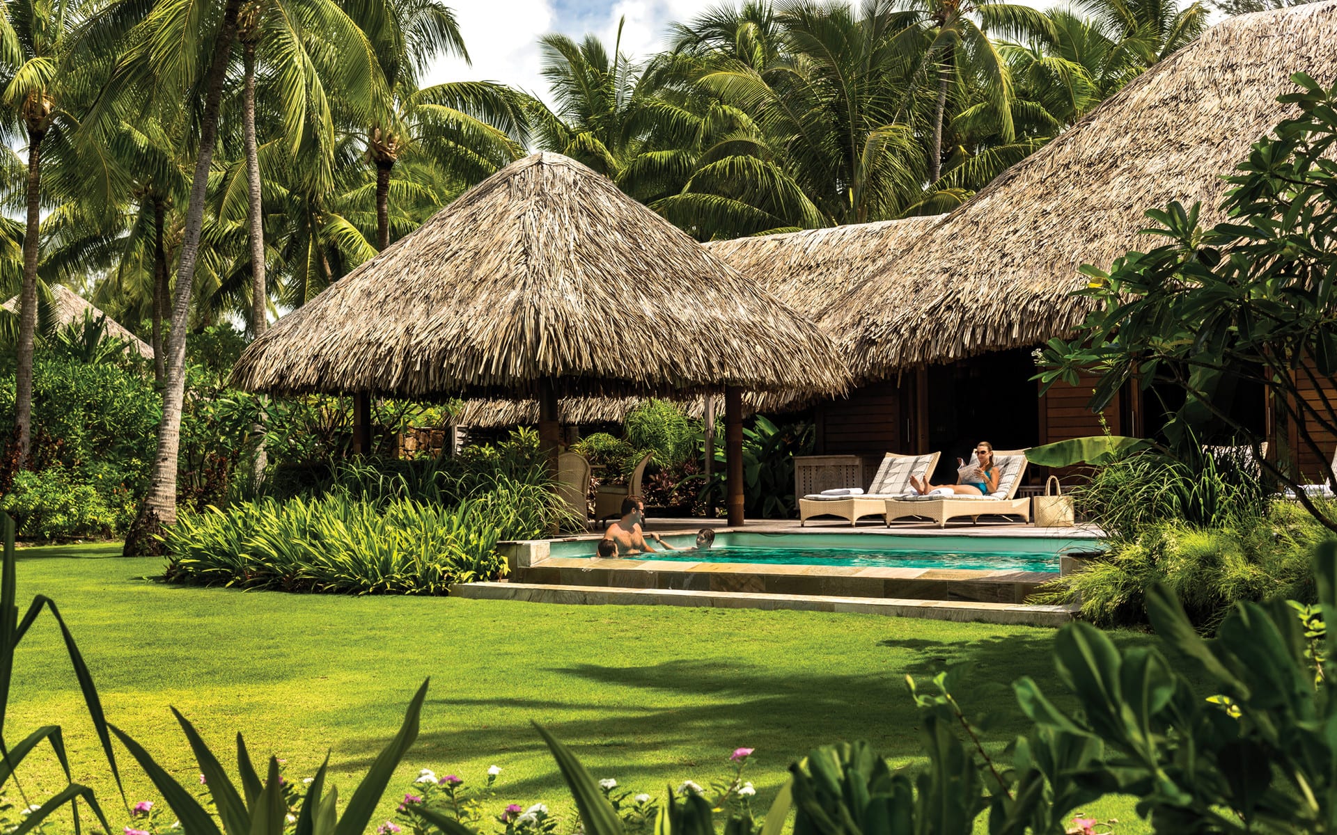Beach front villa with family in swimming pool