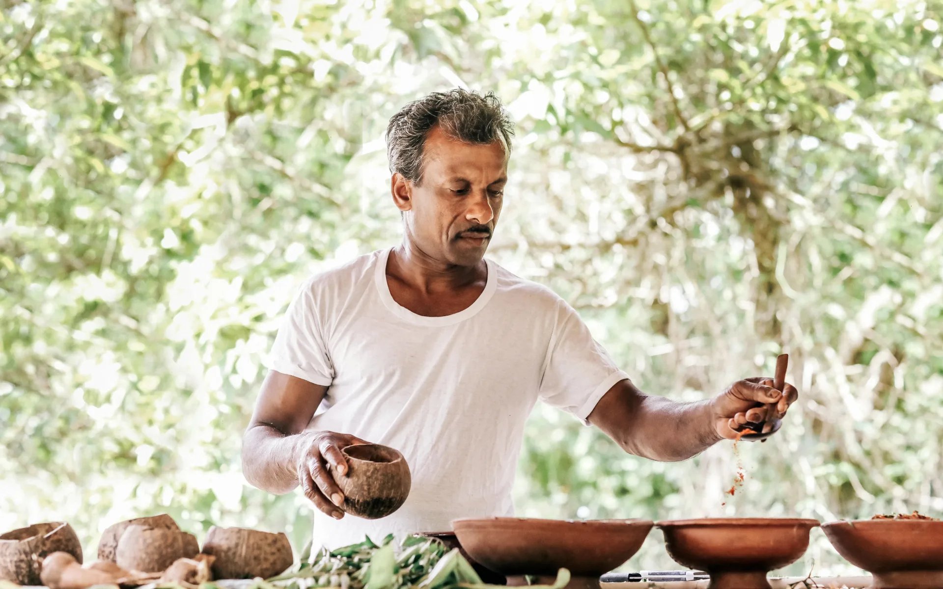 A man gives a cooking lesson at the lodge.