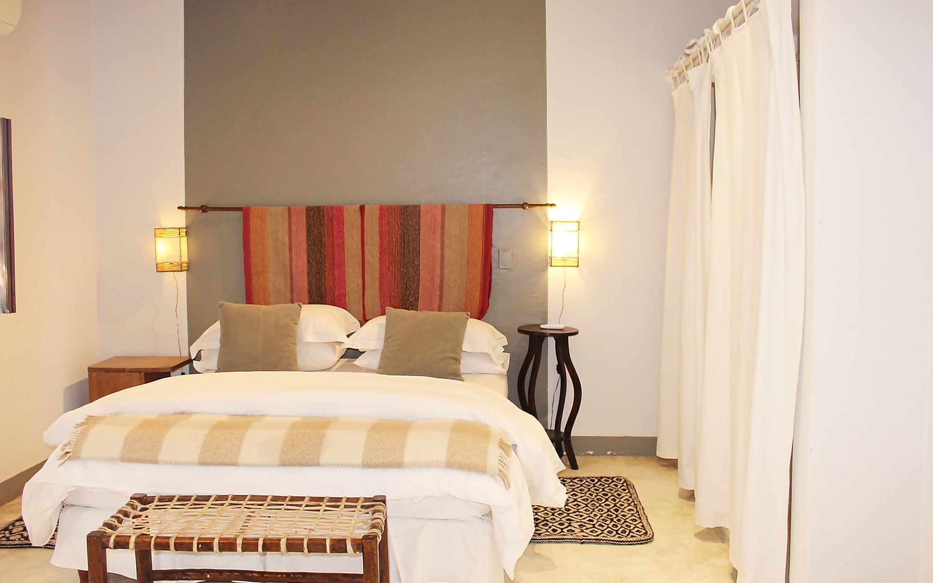 The rooms at Finca-Valentina are designed with a down-to-earth theme, with rugs, red tapestries, leather seats and low-hanging lights.