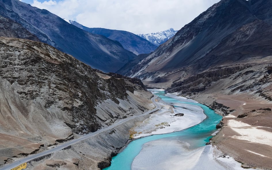 Mountain road running along side blue river
