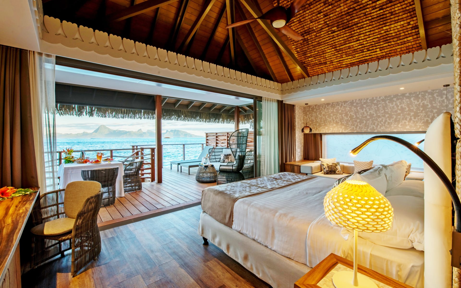 A king-sized bed overlooks a balcony. 
