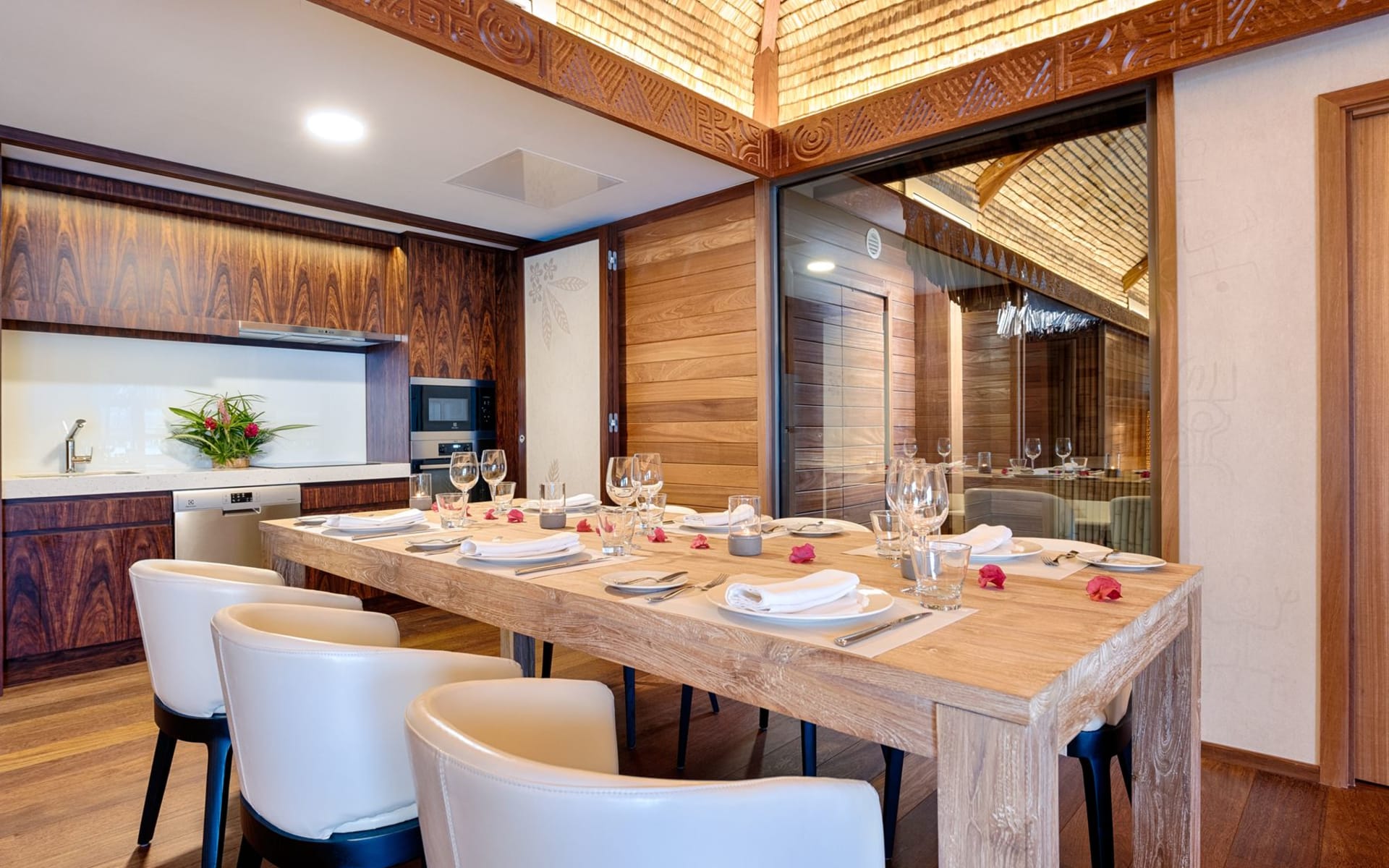 A dining table is set up with glasses and plates. 