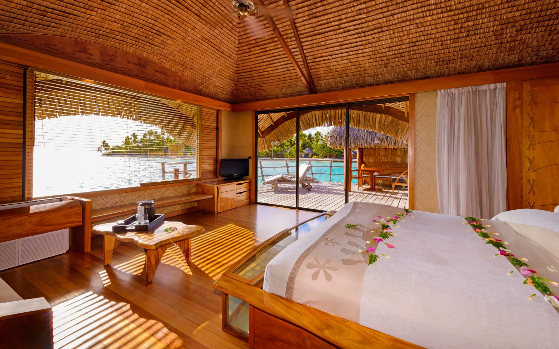 Bedroom area of an ocean view overwater suite