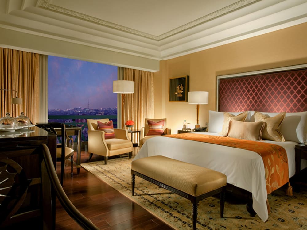 A luxury bedroom with an additional seating area