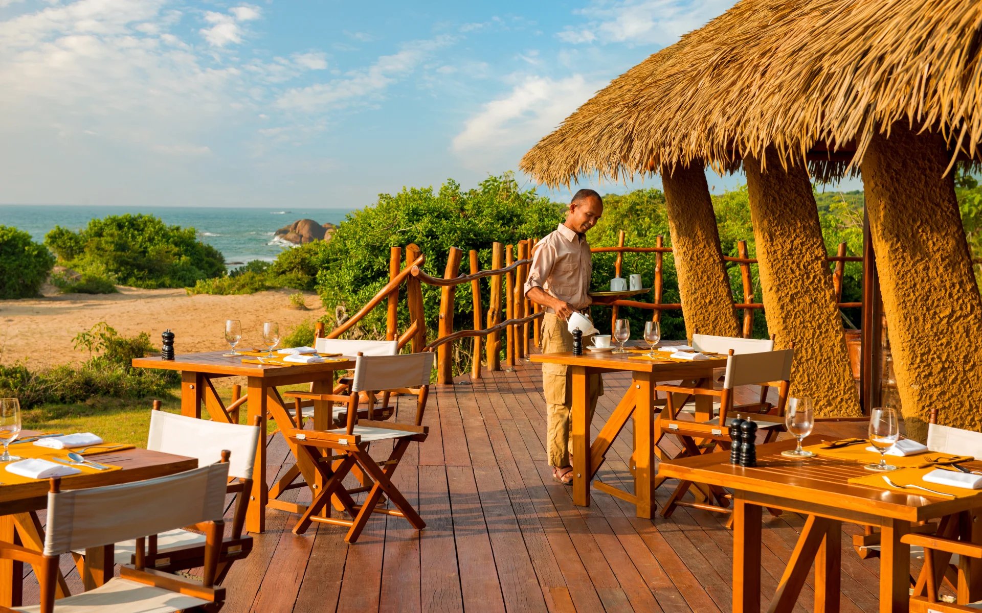 The restaurant is on a wooden deck overlooking the ocean. 