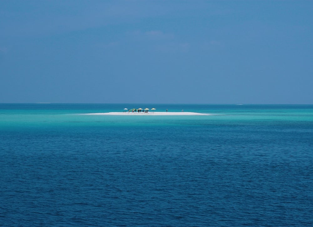 People relax on a remote island in the Maldives.