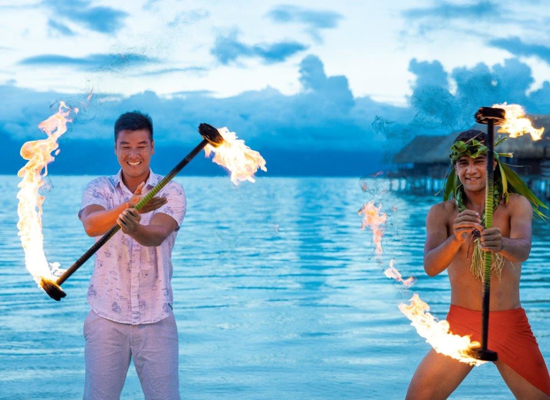 Man trying out fire stick throwing