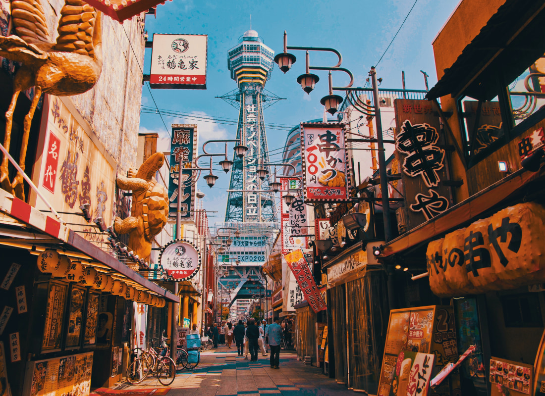 People walk on the street during the daytime in Osaka. 
