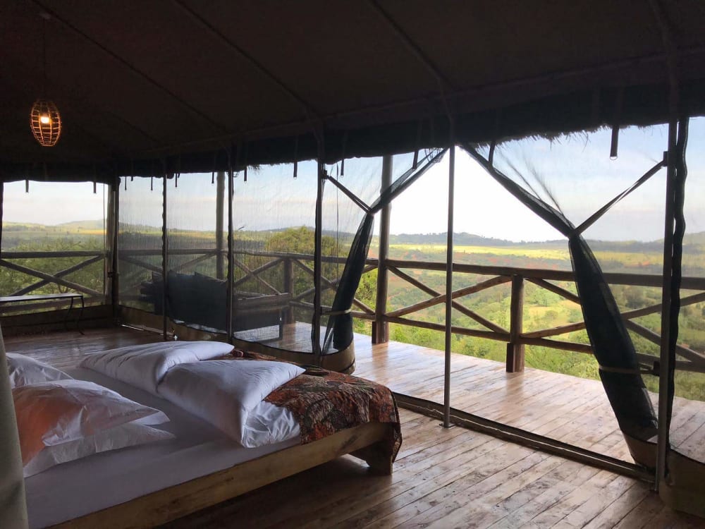 A tent with a balcony and country views