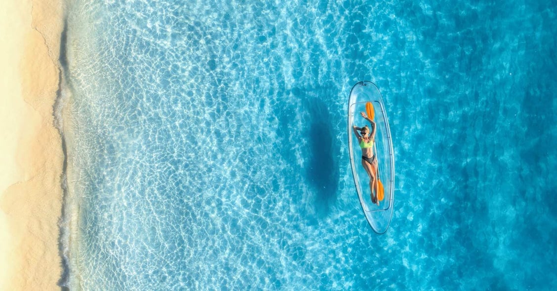 A lady sunbaths on a lilo in the Seychelles.
