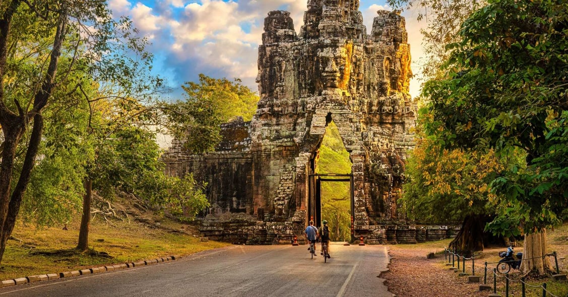 A cyclist rides by Angkor Wat in Cambodia.