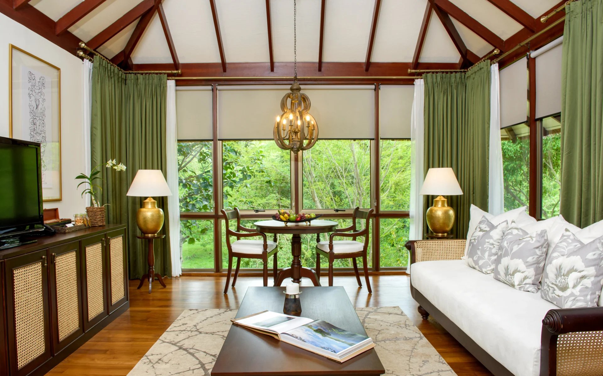 One of the living spaces in the villas is dressed in old-timely, colonial furnishings and decor, accented by olive green tones.