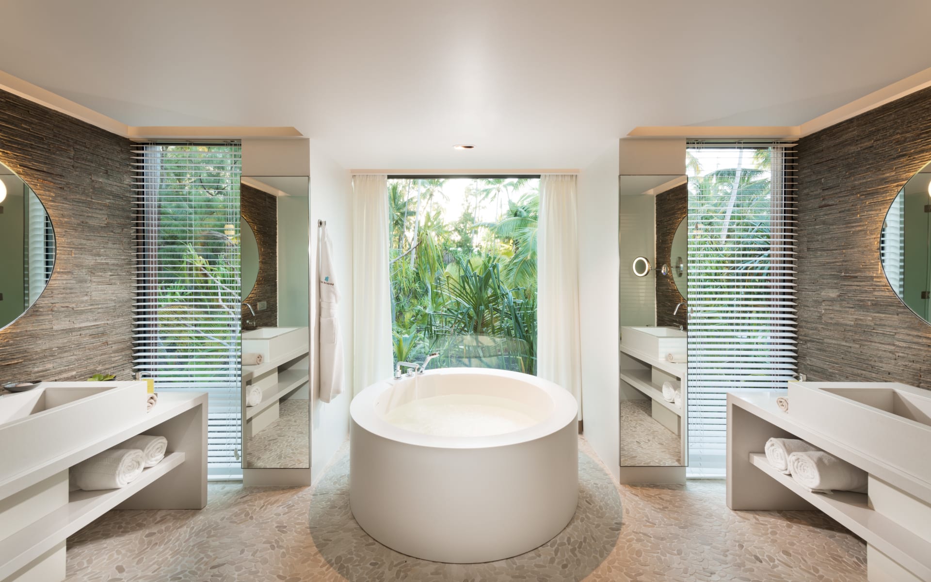 Stunning bath in centre of elegant bathroom
