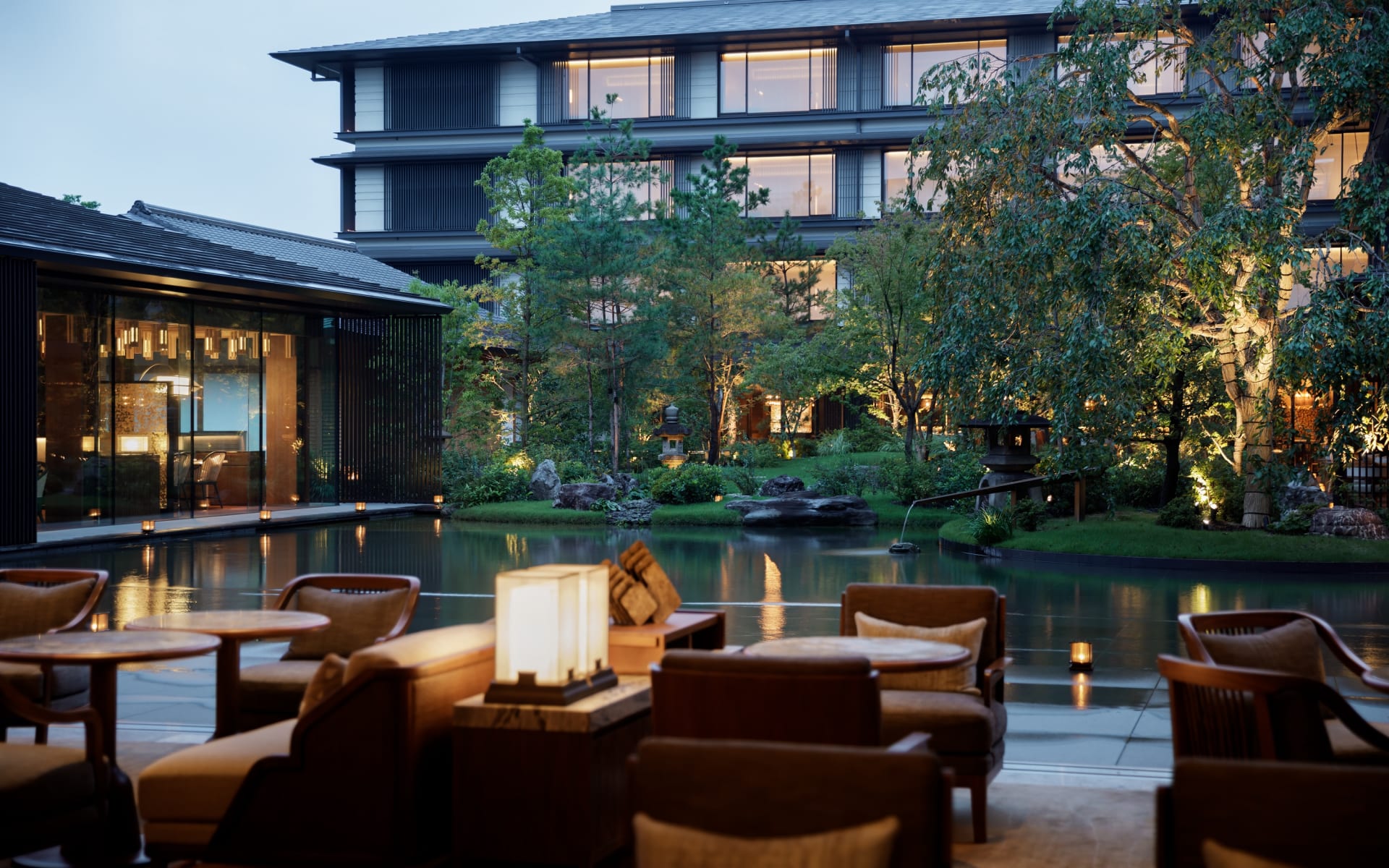The Mitsui lounge has low, brown chairs, lanterns and a pond. 