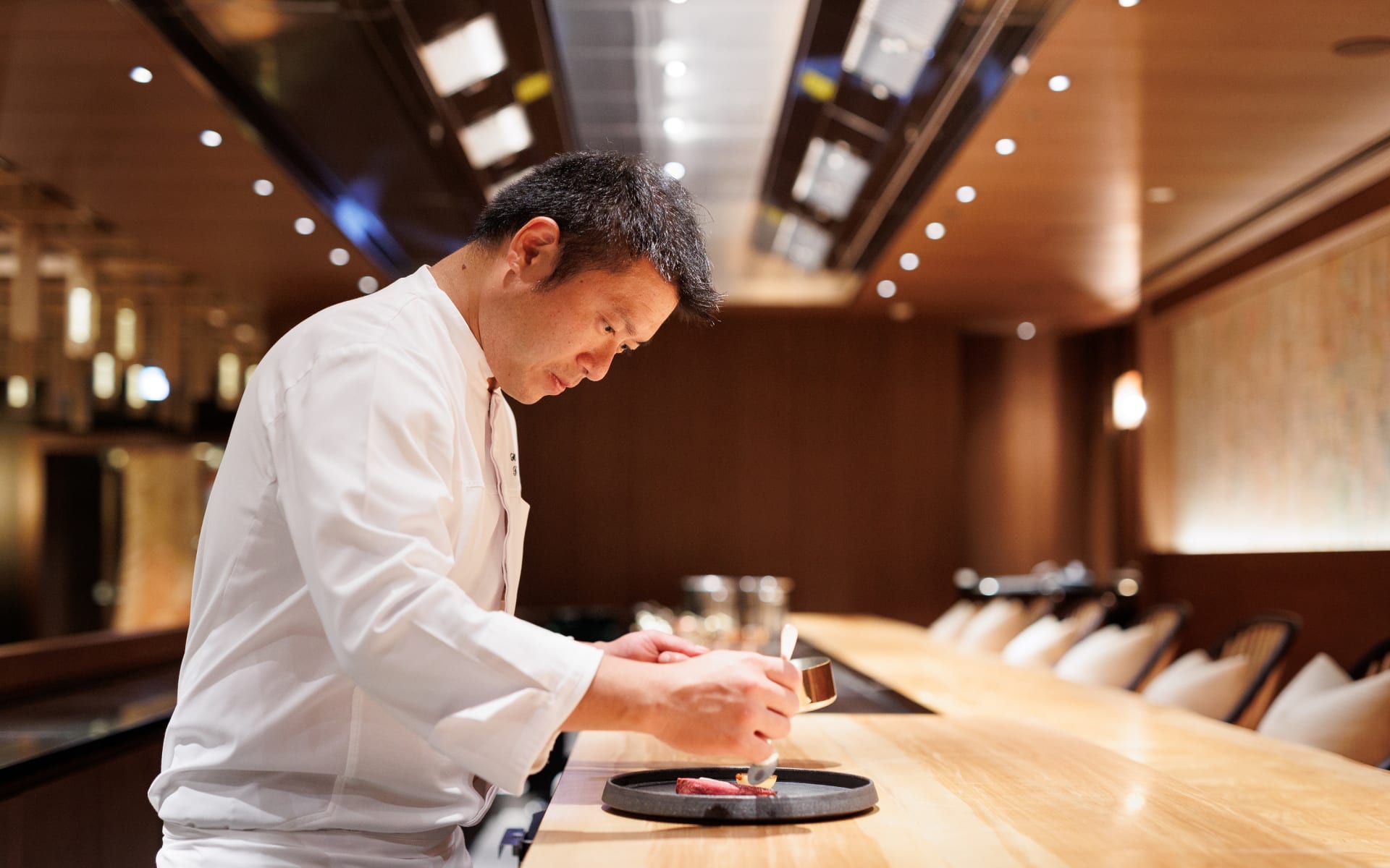 A chef is preparing desert at The Mitsui Hotel.