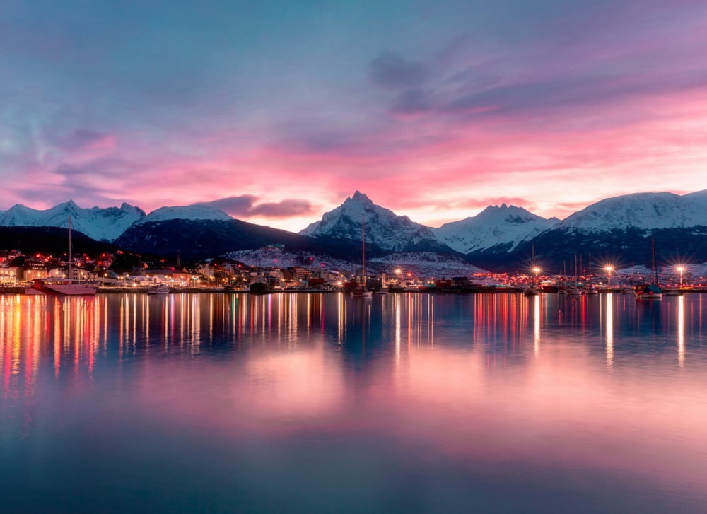 Tierra del Fuego has a lake reflecting the night lights during early evening.