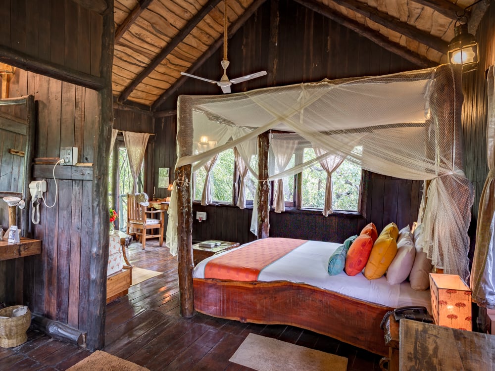 Bedroom with canopy bed and bathroom