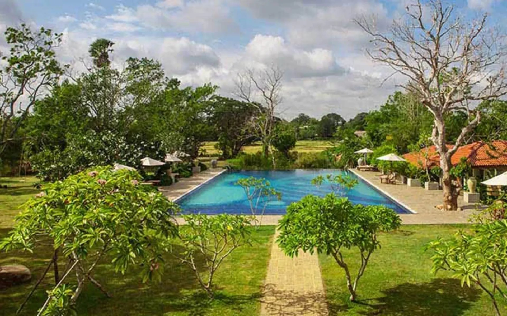 The main pool at the resort is rectangular and large, surrounded by decking with sun loungers.