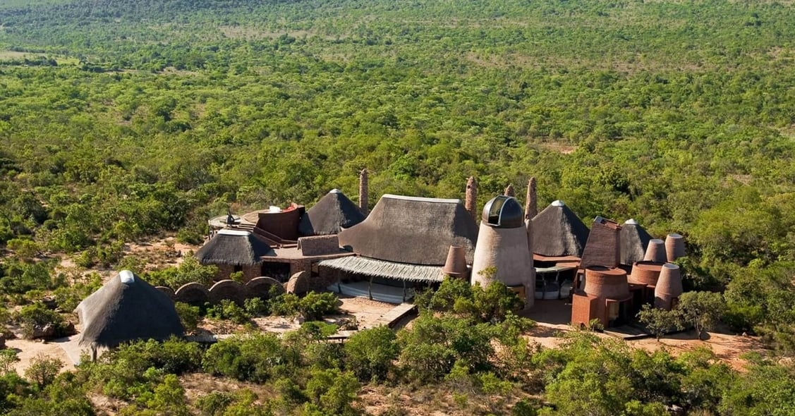A stunning landscape of Pams Leobo, featuring expansive views of the natural terrain with rolling hills and vibrant vegetation