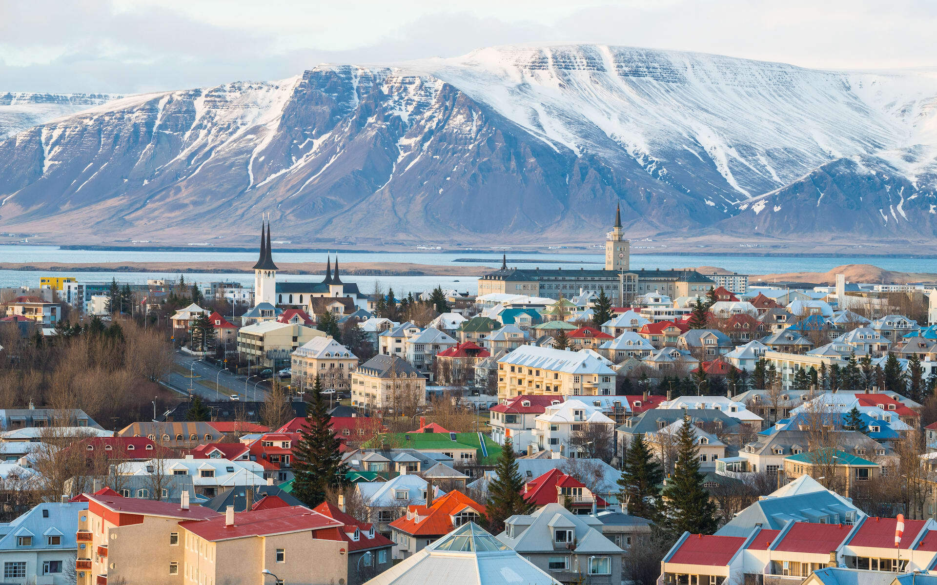 Reykjavik during winter backs onto snow covered mountains.