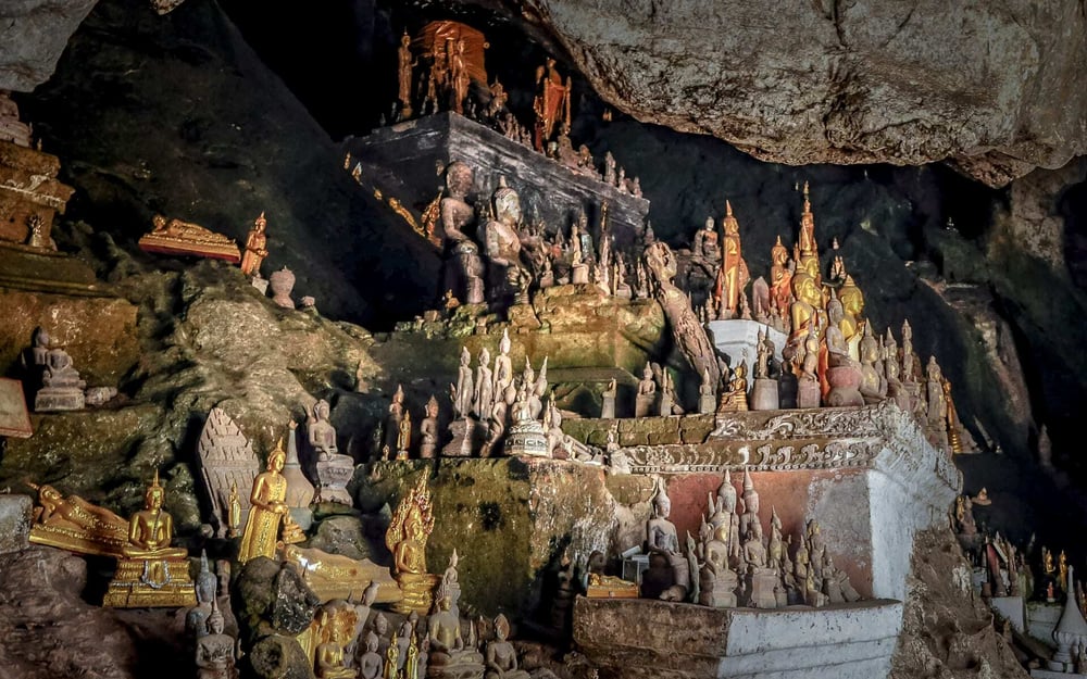 A selection of Buddha sculptures fill the interior of Pak Ou Caves.