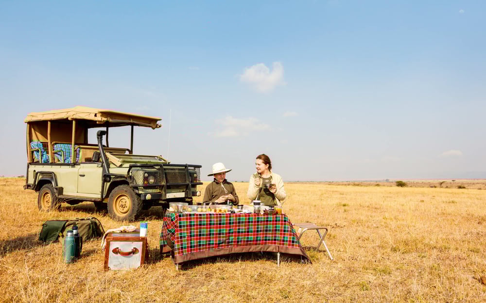 A couple enjoy a bush breakfast on the grasslands.