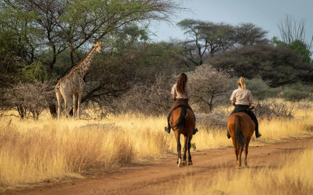 Two women enjoy a horseback safari in Namibia.