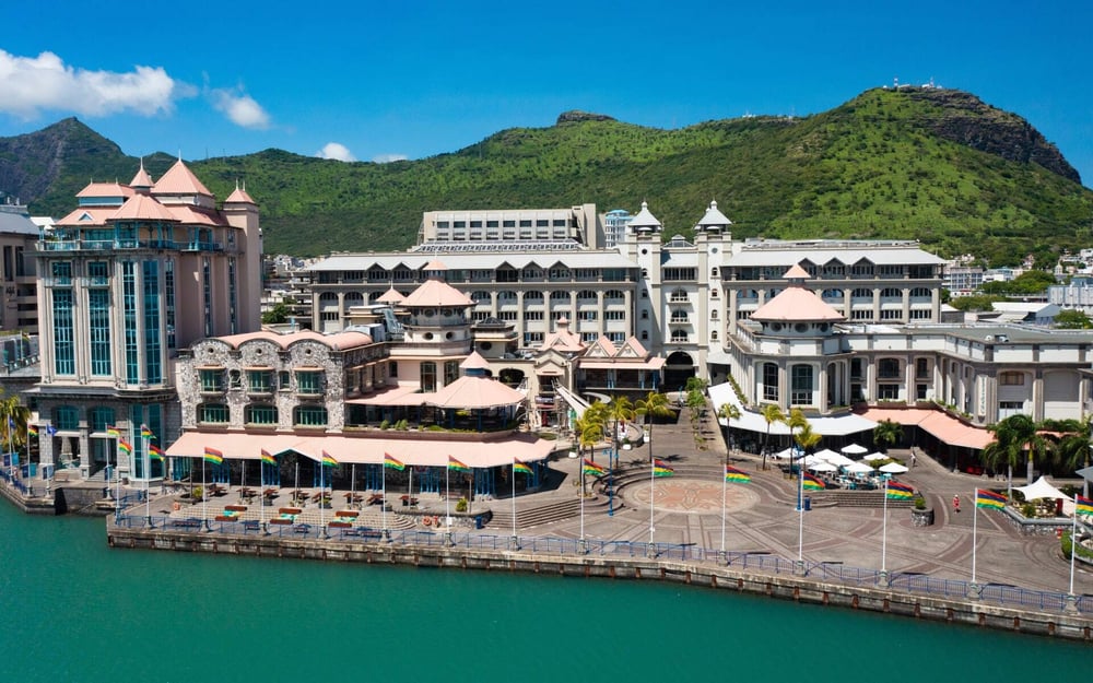 The waterfront of Port Louis has modern, white buildings.