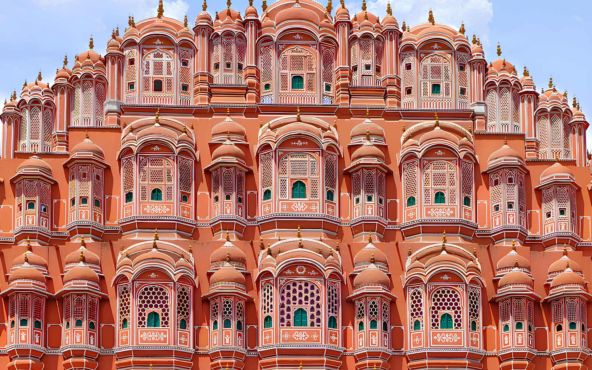 The Hawa Mahal has red/pink exteriors with an intricate design.