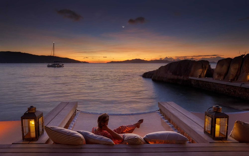 A guest enjoys the sunset at Six Senses Zil Pasyon.
