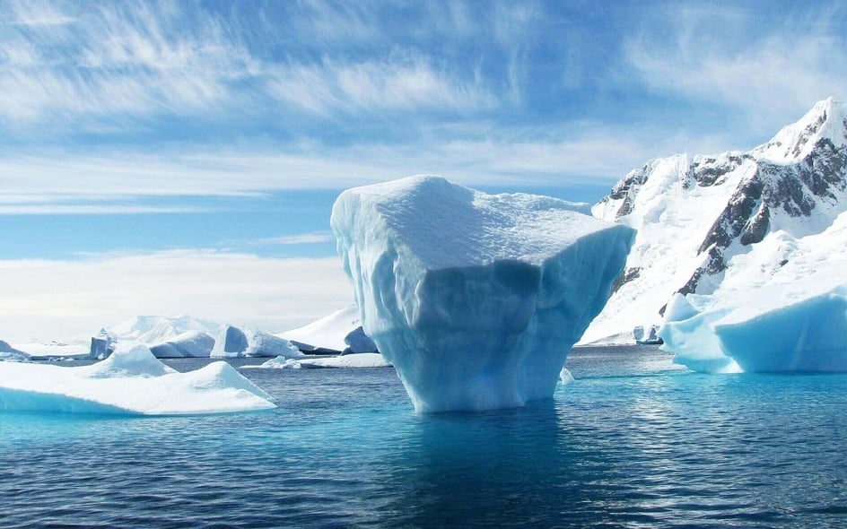 A view of an iceberg floating in the ocean in Antarctica