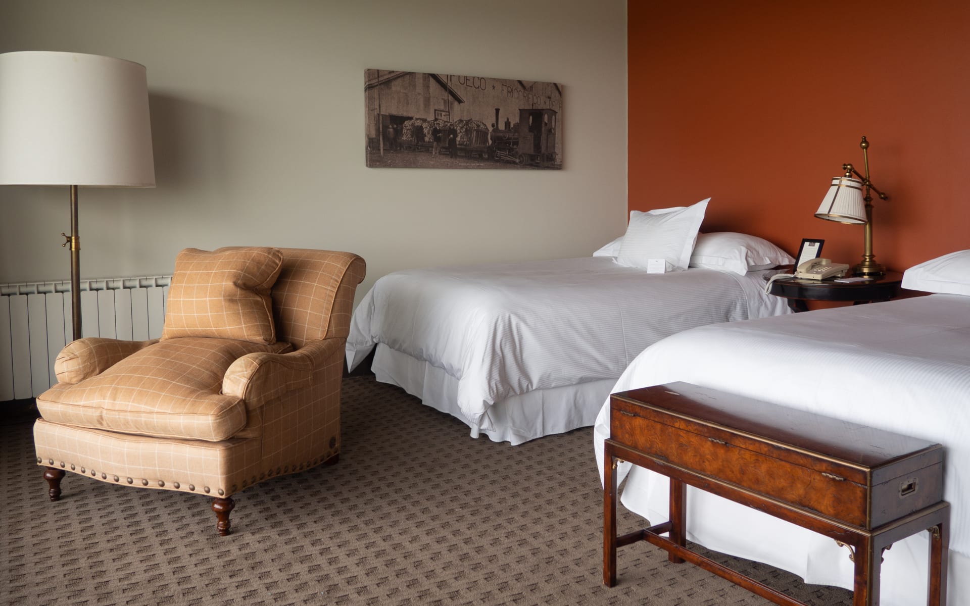 Two twin beds and an armchair make up the twin bedroom at The Singular Patagonia. 