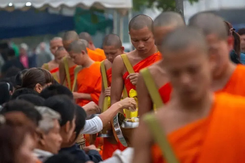 buddhist_monks_receiving_alms_luang_prabang_laos-1