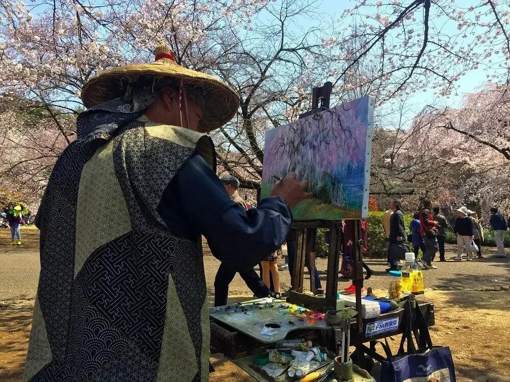 japanese_man_painting_sakura_park_cherry_blossom_viewing_japan