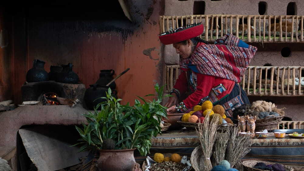 Indigenous woman preparing natural dyes for traditional textile dyeing