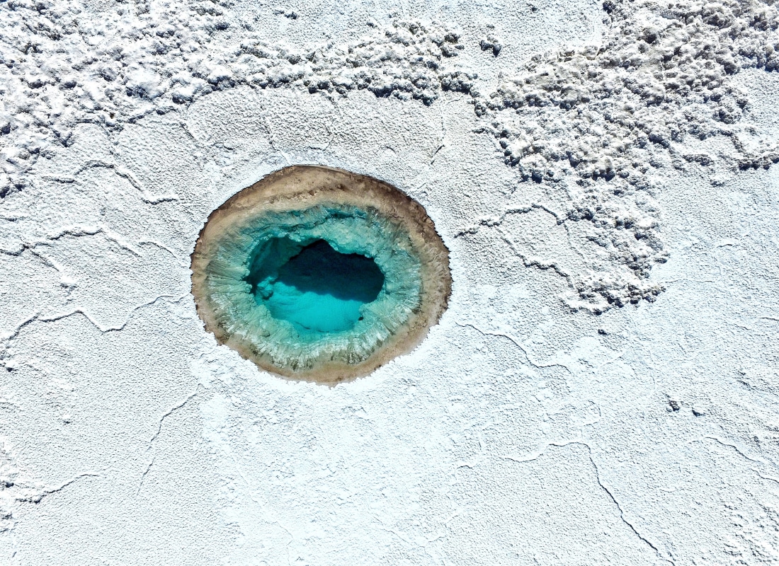 San Pedro de Atacama has a hole in the white sand with blue-turquoise water. 