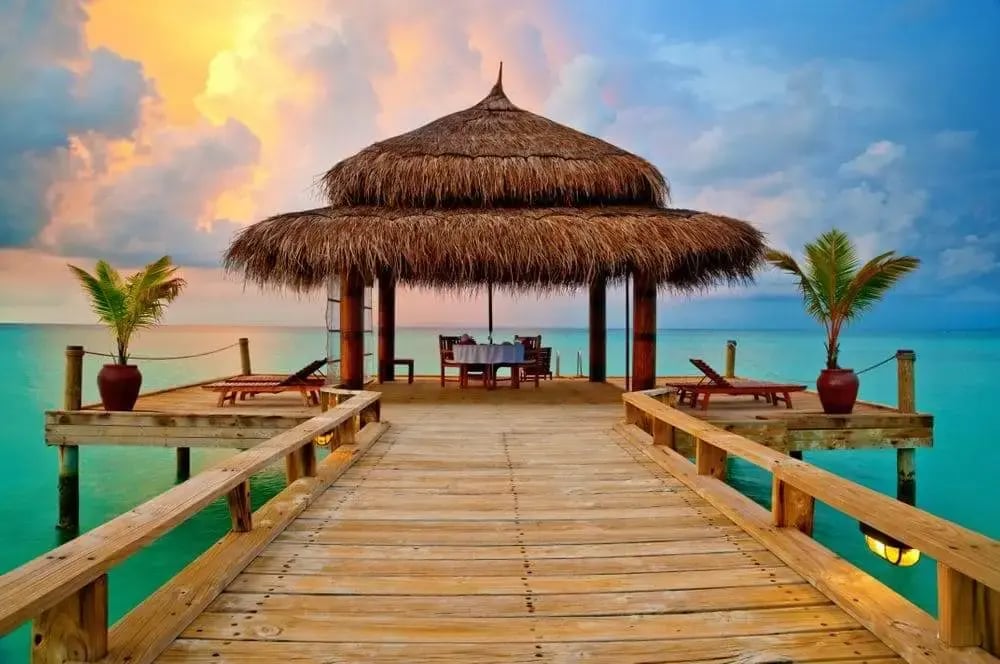 tropical_hut_sunset_on_water_maldives