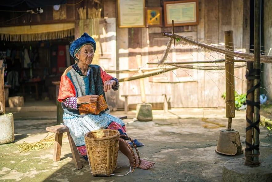 Hmong ethnic artisans are spinning flax to weave brocade