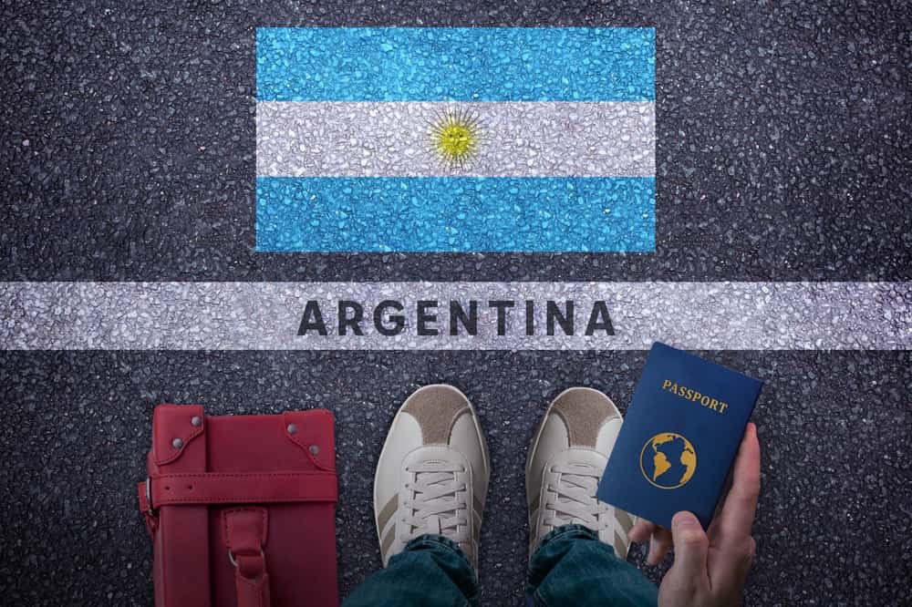 Traveler with bag, passport and Argentina flag